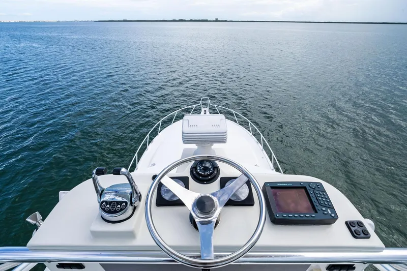 Pescador Yacht Photos Pics Helm view of 2004 Cabo 40 Hardtop Express yacht on open water.