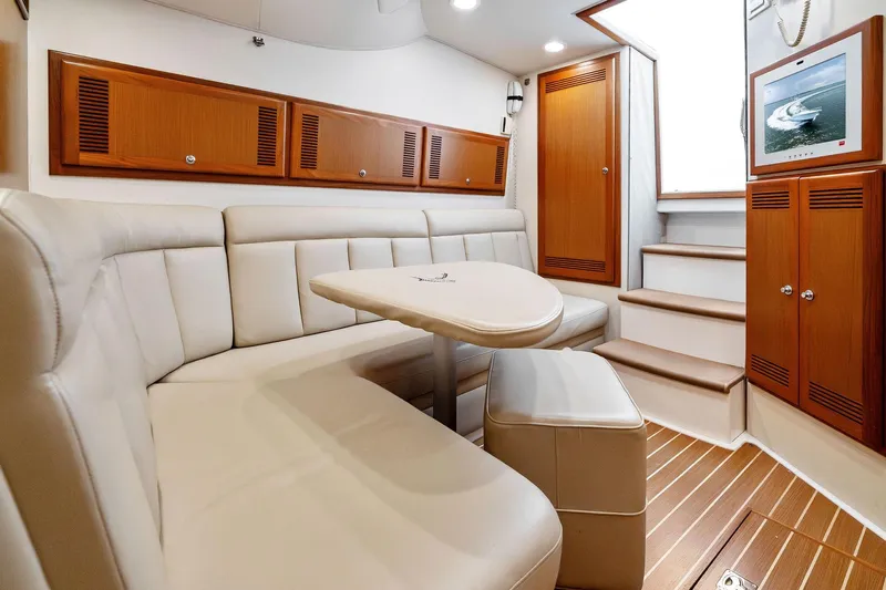 Pescador Yacht Photos Pics Luxurious interior of 2004 Cabo 40 Hardtop Express yacht with plush seating and wooden accents.