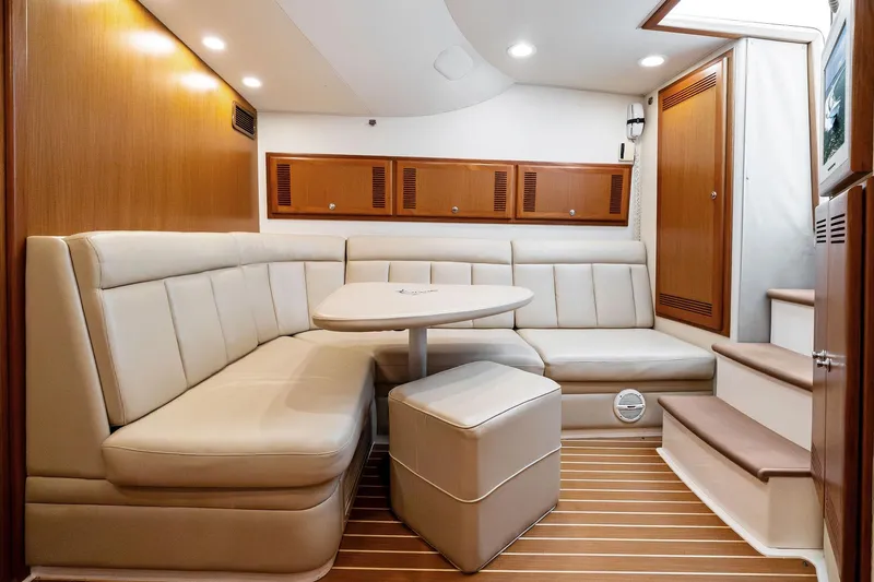 Pescador Yacht Photos Pics Luxurious interior of 2004 Cabo 40 Hardtop Express yacht with plush seating and wooden accents.