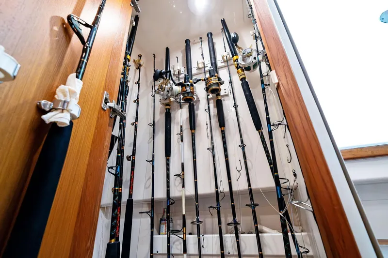 Pescador Yacht Photos Pics Fishing rods stored vertically in a wooden cabinet on a 2004 Cabo 40 Hardtop Express boat.