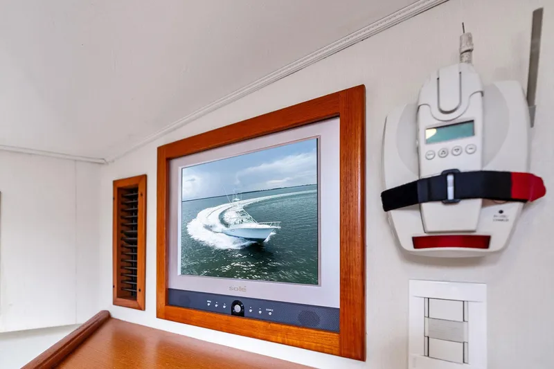 Pescador Yacht Photos Pics Interior of 2004 Cabo 40 Hardtop Express with wall-mounted TV and control panel.