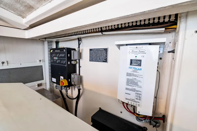 Pescador Yacht Photos Pics Electrical panel and charger inside a 2004 Cabo 40 Hardtop Express boat.