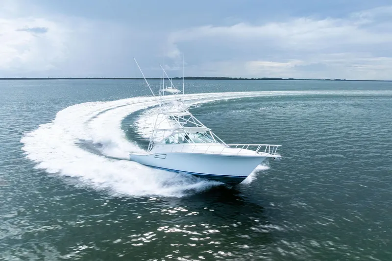 Pescador Yacht Photos Pics 2004 Cabo 40 Hardtop Express yacht making a sharp turn on open water.