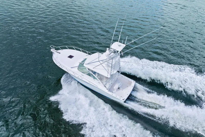 Pescador Yacht Photos Pics 2004 Cabo 40 Hardtop Express yacht cruising on open water, aerial view.