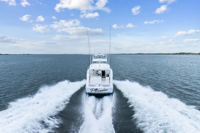 Pescador Yacht Photos Pics 2004 Cabo 40 Hardtop Express cruising on open water under a blue sky.