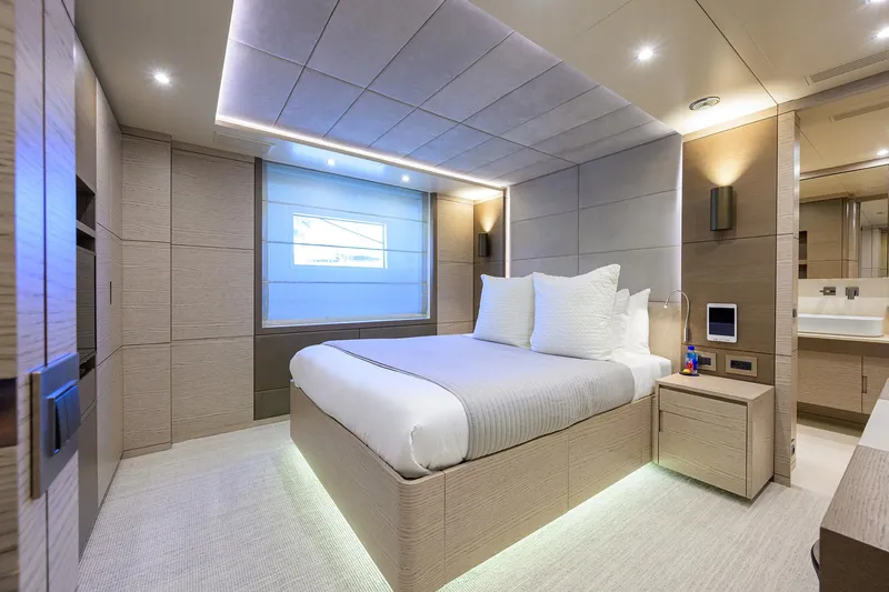 Cofina Yacht Photos Pics Luxurious bedroom interior on 2016 Benetti 132 Classic Supreme yacht, featuring modern design and ambient lighting.