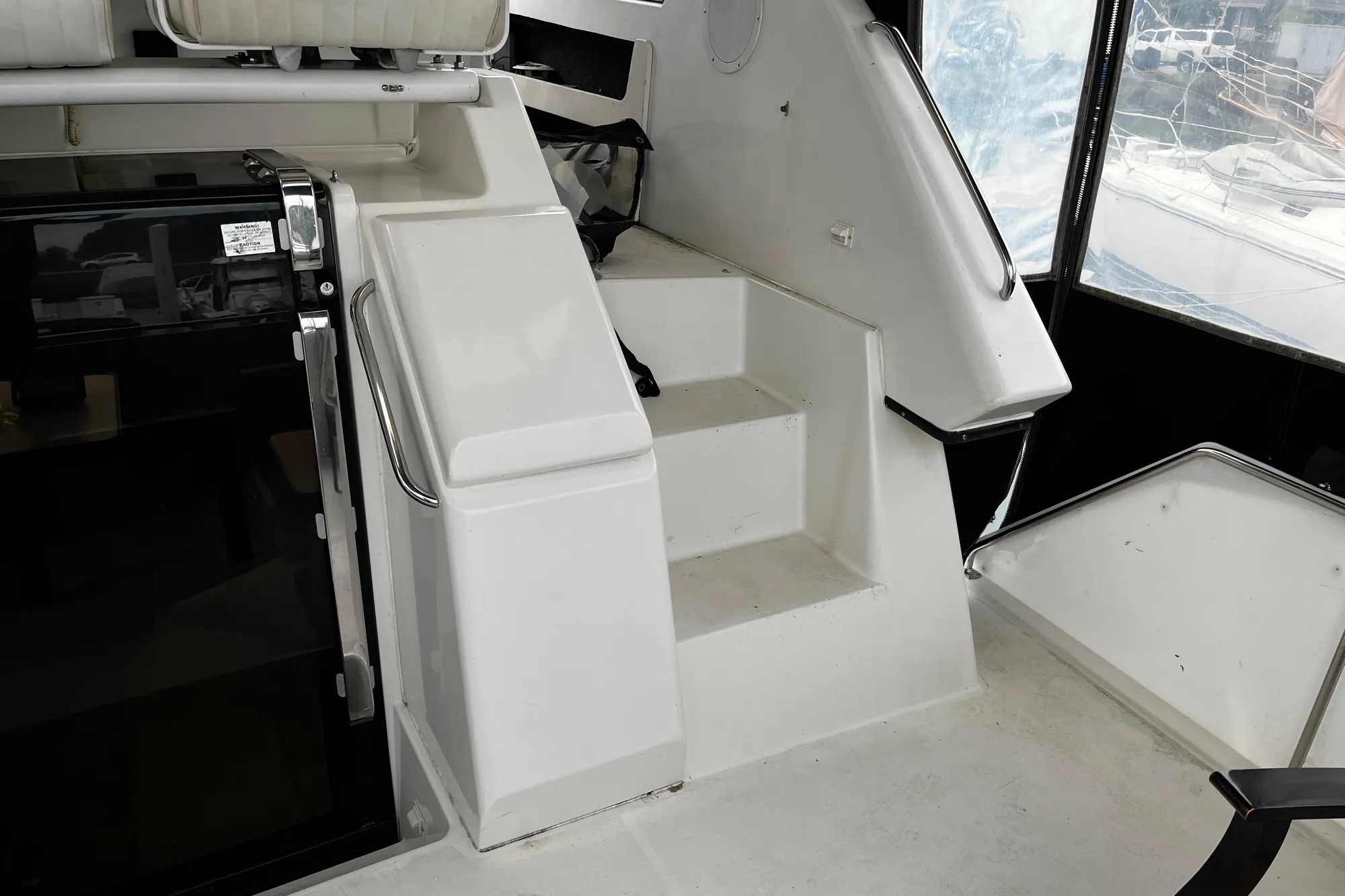 Staircase inside 1991 Carver 33 Aft Cabin Motor Yacht, featuring sleek white design.