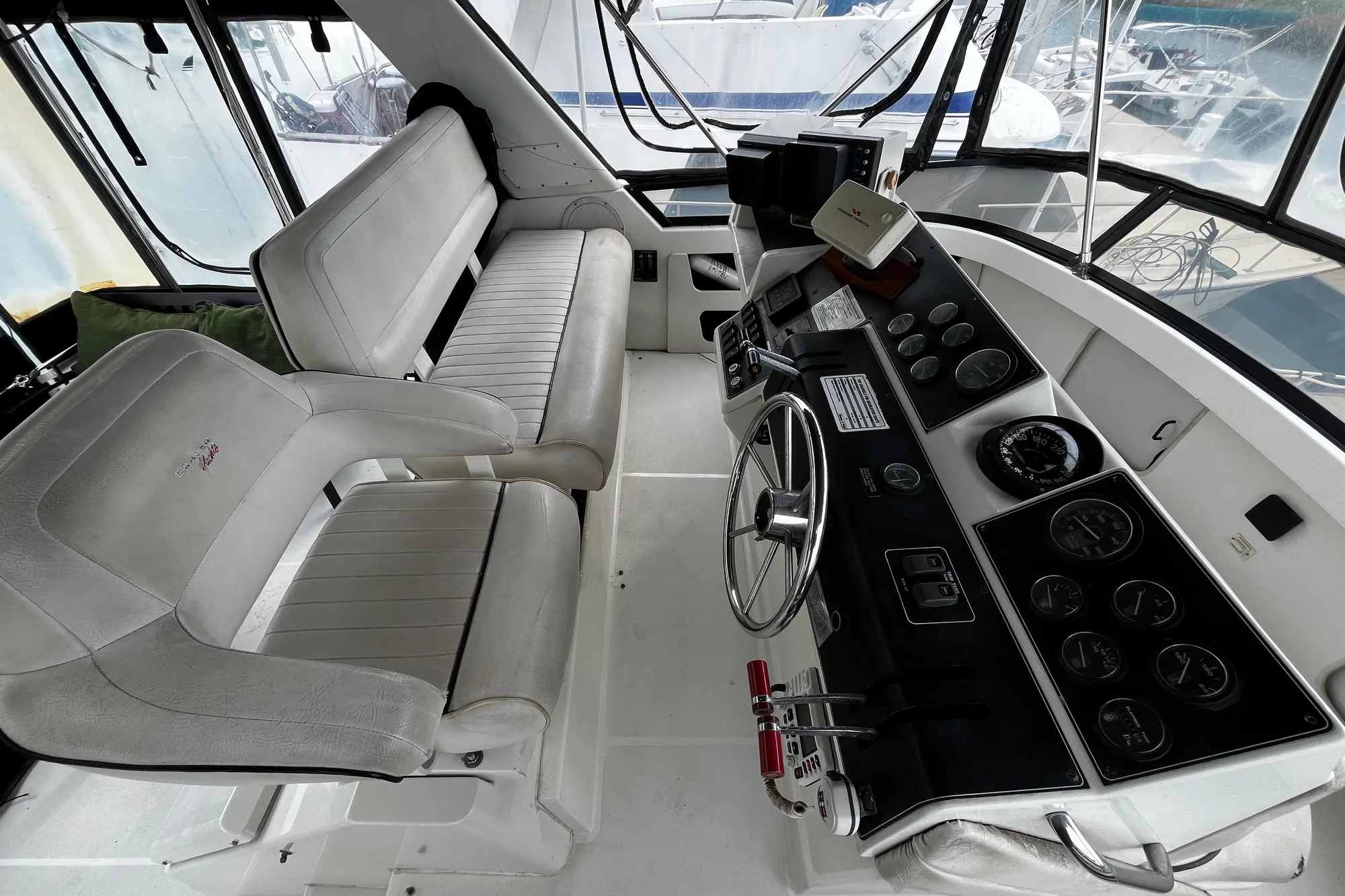 1991 Carver 33 Aft Cabin Motor Yacht helm with dual seating and instrument panel.