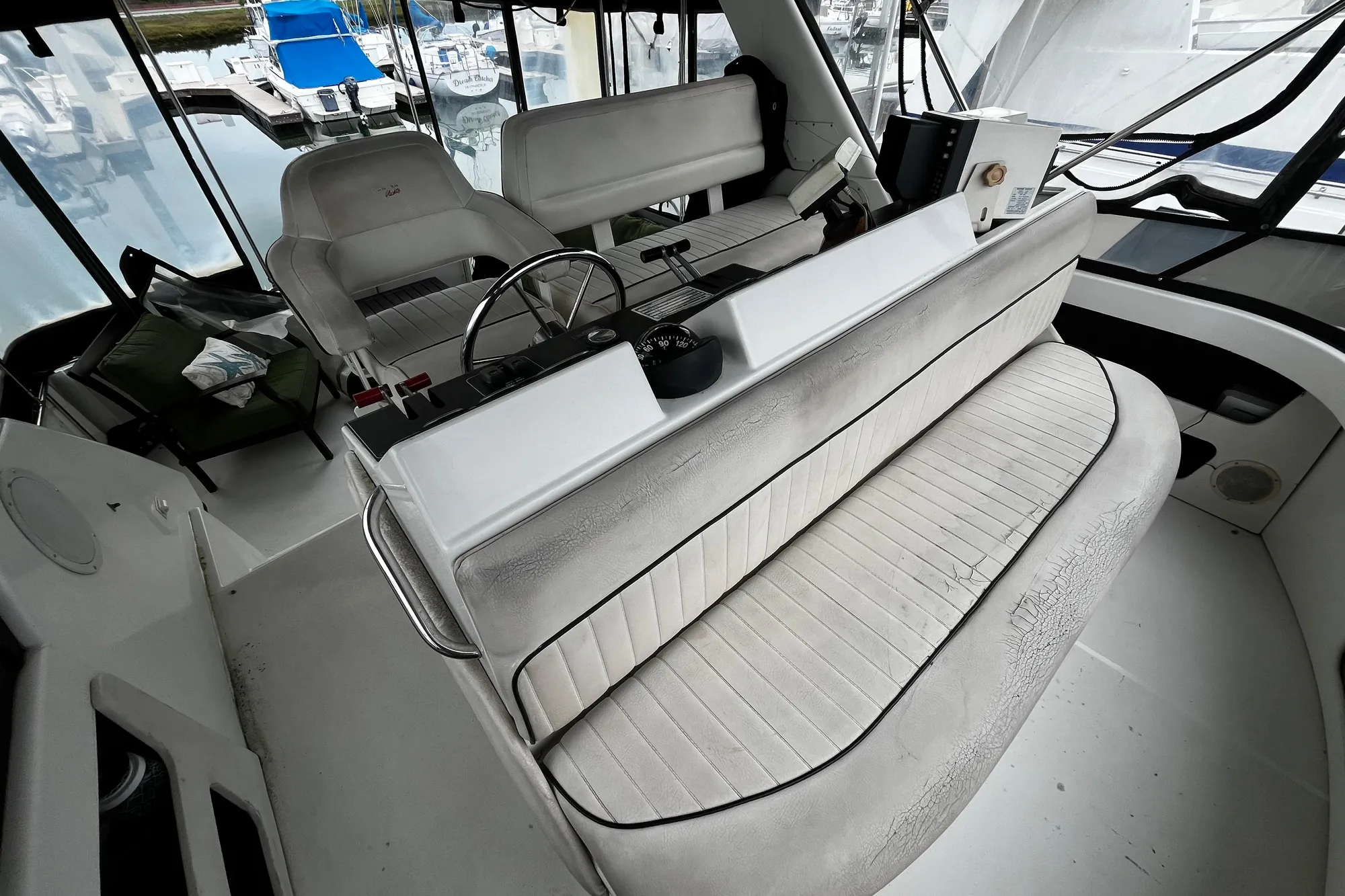 1991 Carver 33 Aft Cabin Motor Yacht interior with helm and seating area.