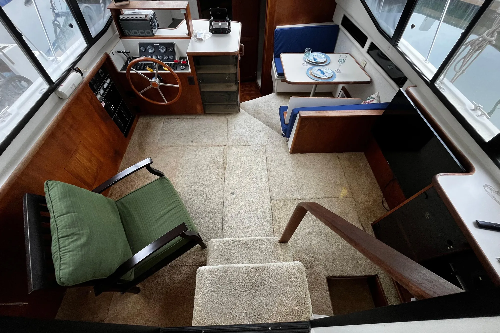 Interior of 1991 Carver 33 Aft Cabin Motor Yacht with helm, seating, and dining area.