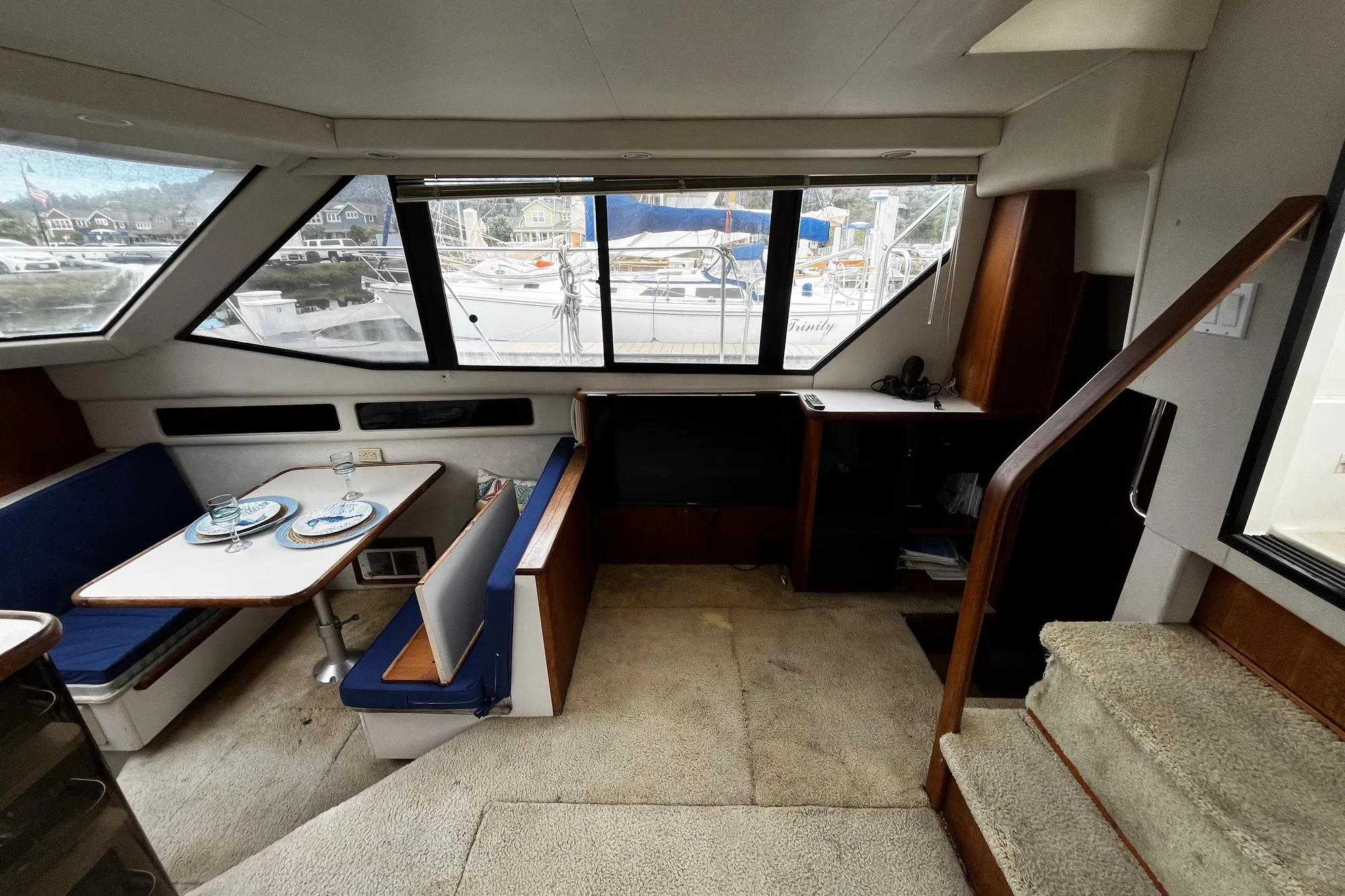 Interior of 1991 Carver 33 Aft Cabin Motor Yacht with dining area and large windows.