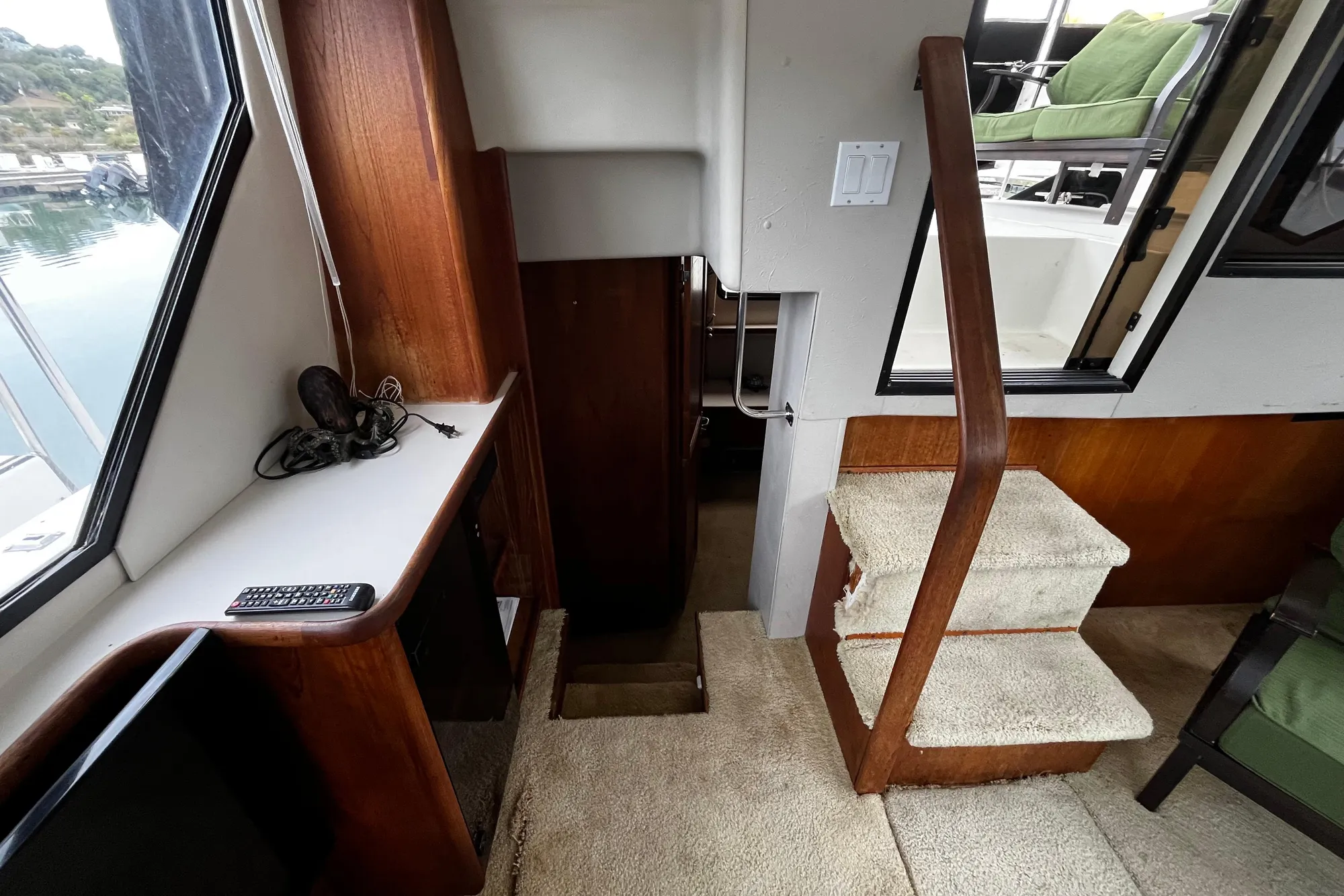 Interior of 1991 Carver 33 Aft Cabin Motor Yacht with stairs and seating area.
