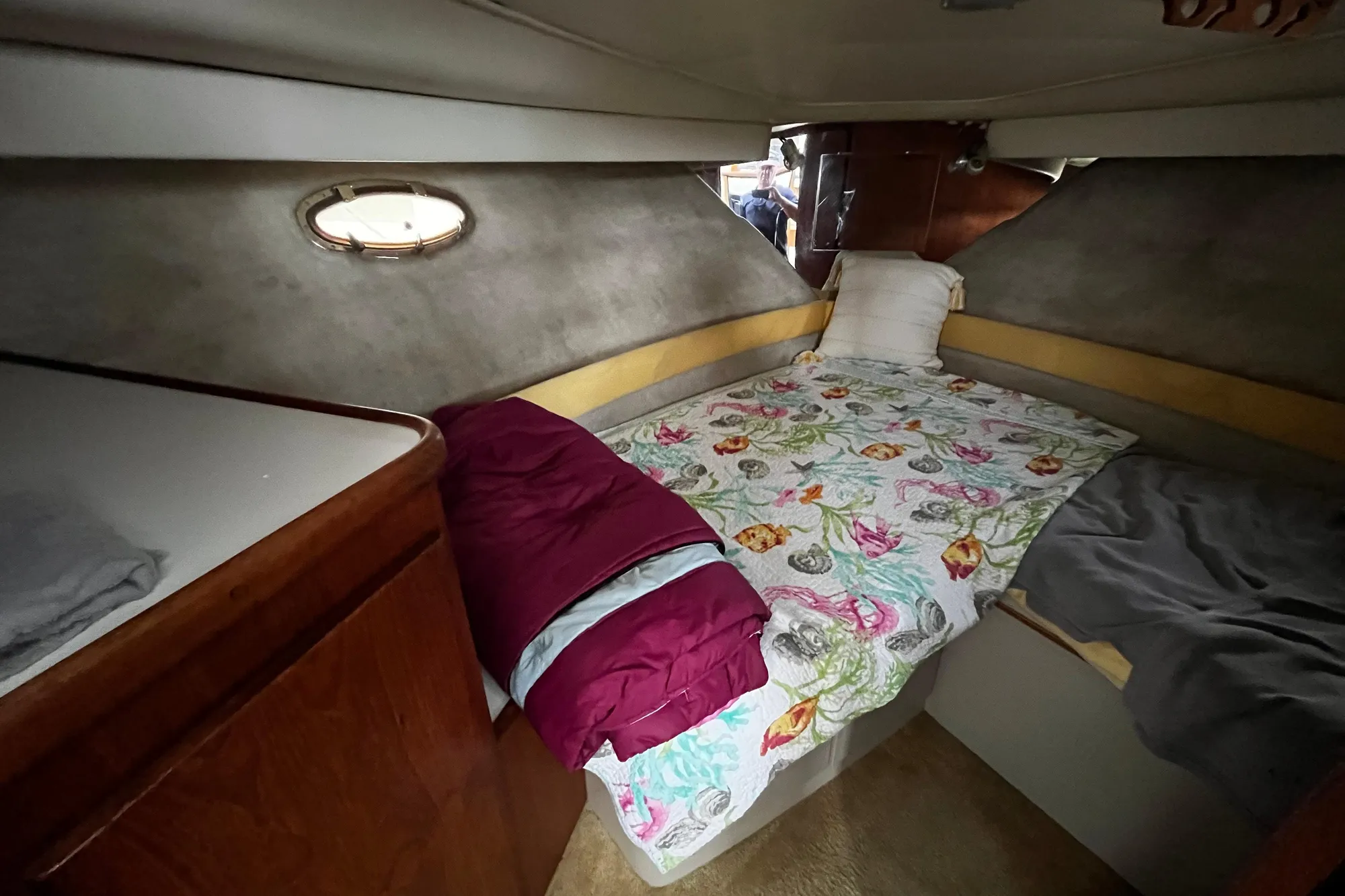 Cozy cabin interior of 1991 Carver 33 Aft Cabin Motor Yacht with floral bedding.