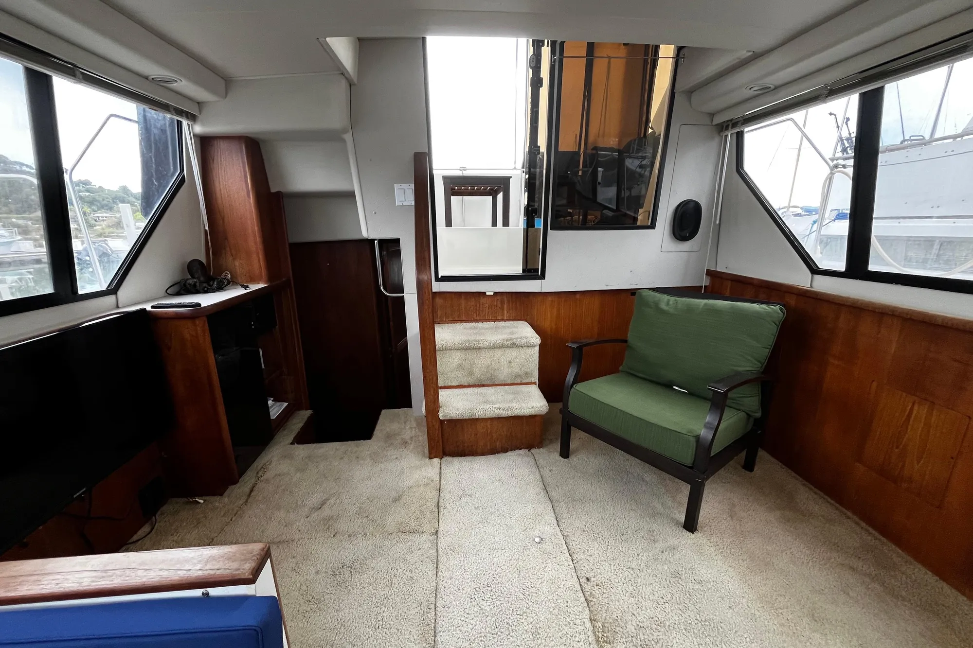 Interior of 1991 Carver 33 Aft Cabin Motor Yacht with seating and stairs.
