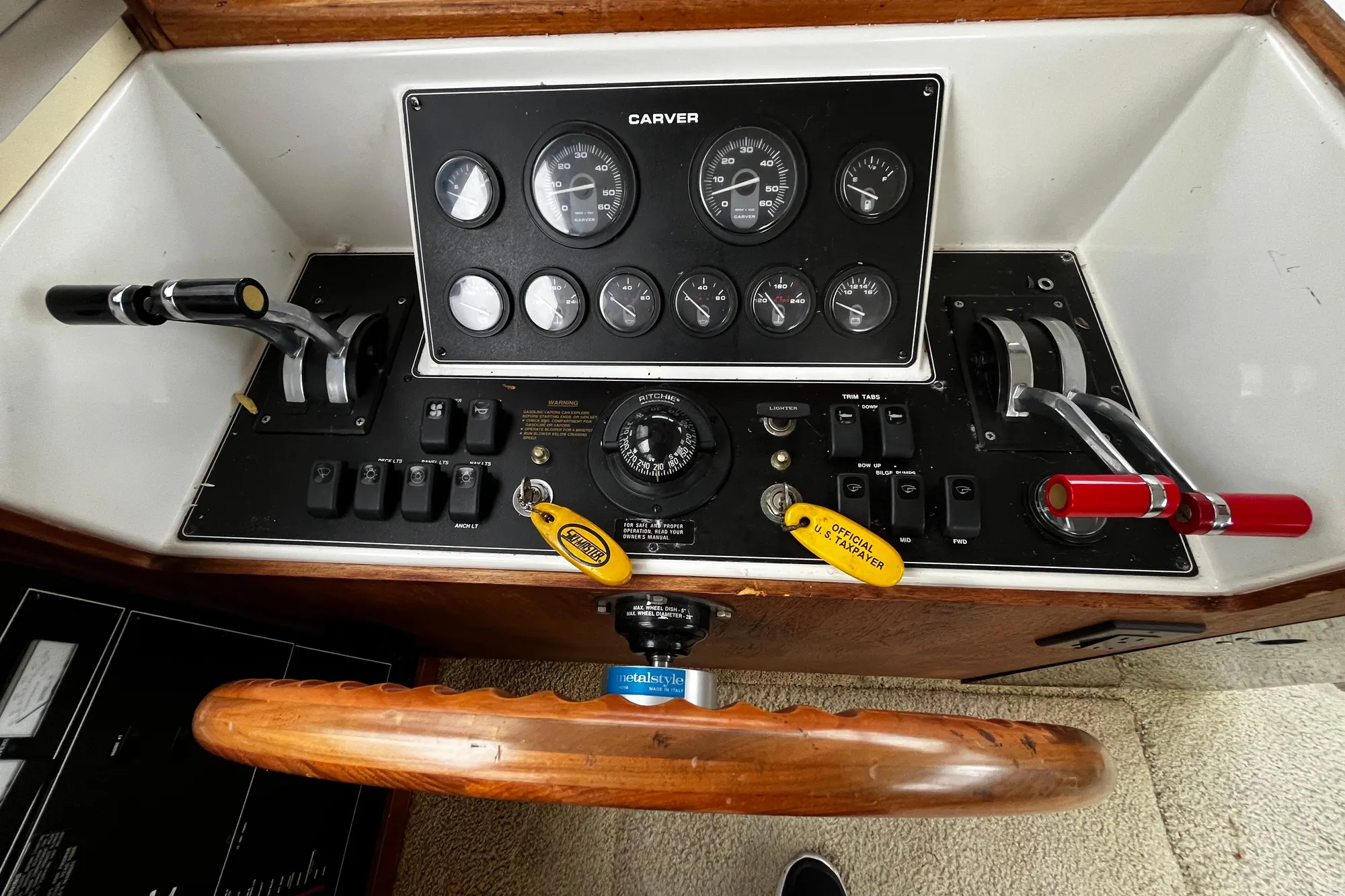 1991 Carver 33 Aft Cabin Motor Yacht control panel with gauges and steering wheel.