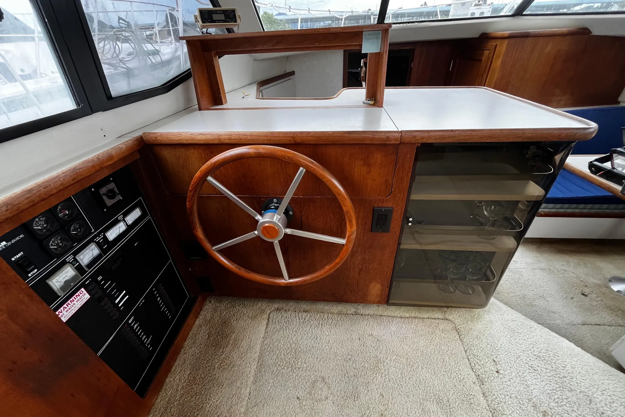 1991 Carver 33 Aft Cabin Motor Yacht helm with wooden steering wheel and control panel.