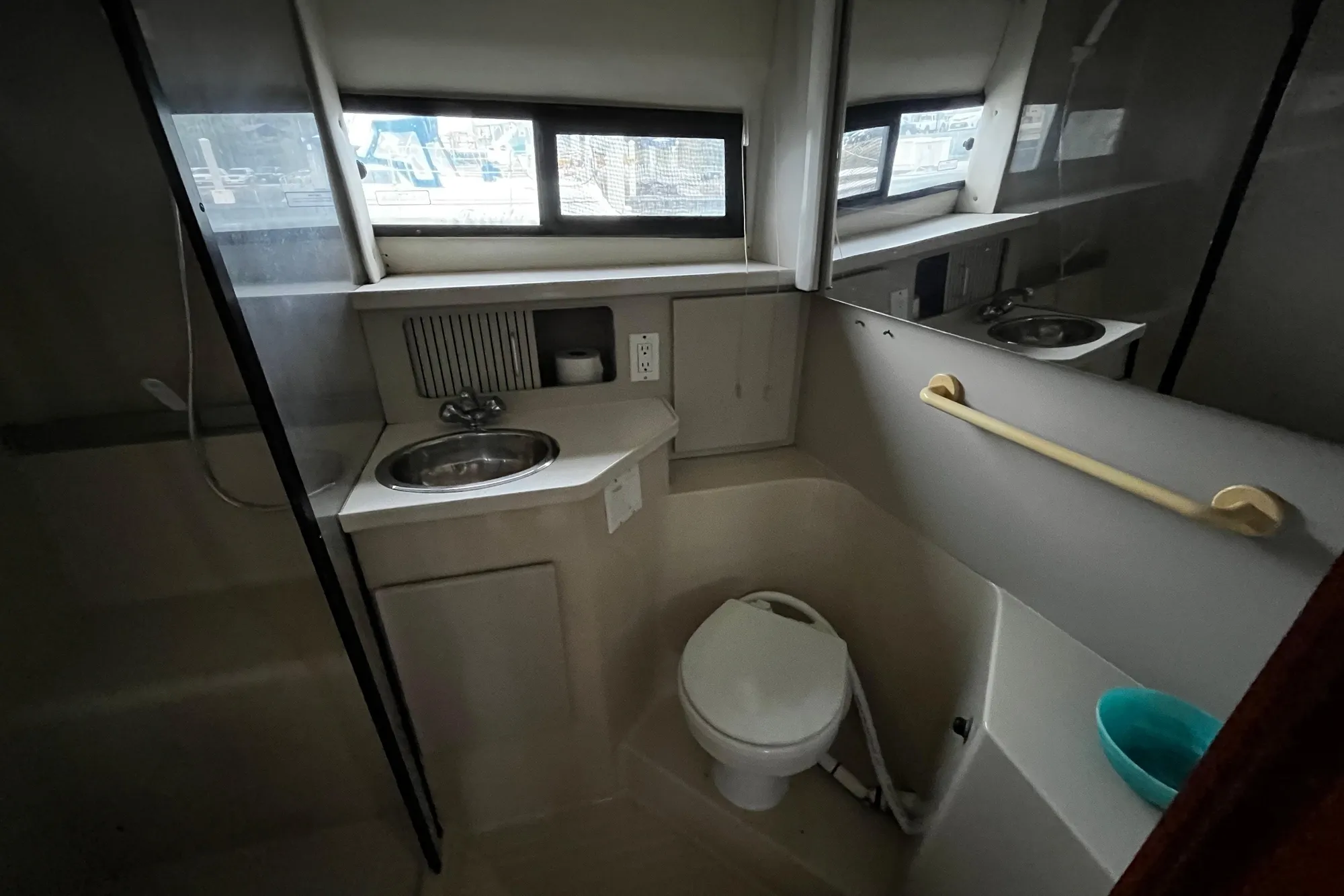 1991 Carver 33 Aft Cabin Motor Yacht bathroom with sink, toilet, and window.