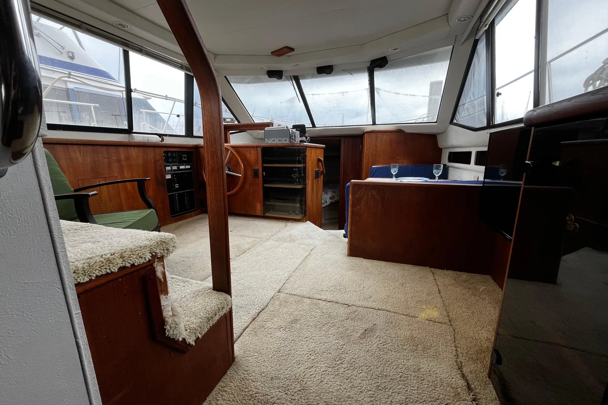 Interior of 1991 Carver 33 Aft Cabin Motor Yacht with wood paneling and seating area.