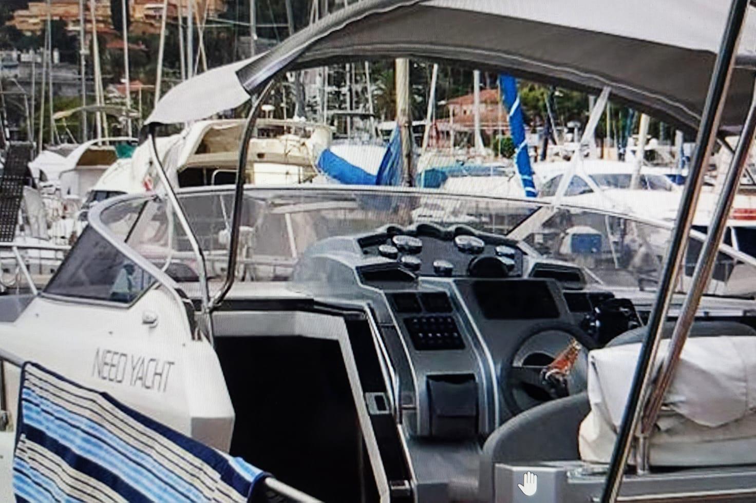 2017 Need Yacht 32 in marina, showcasing cockpit and controls.