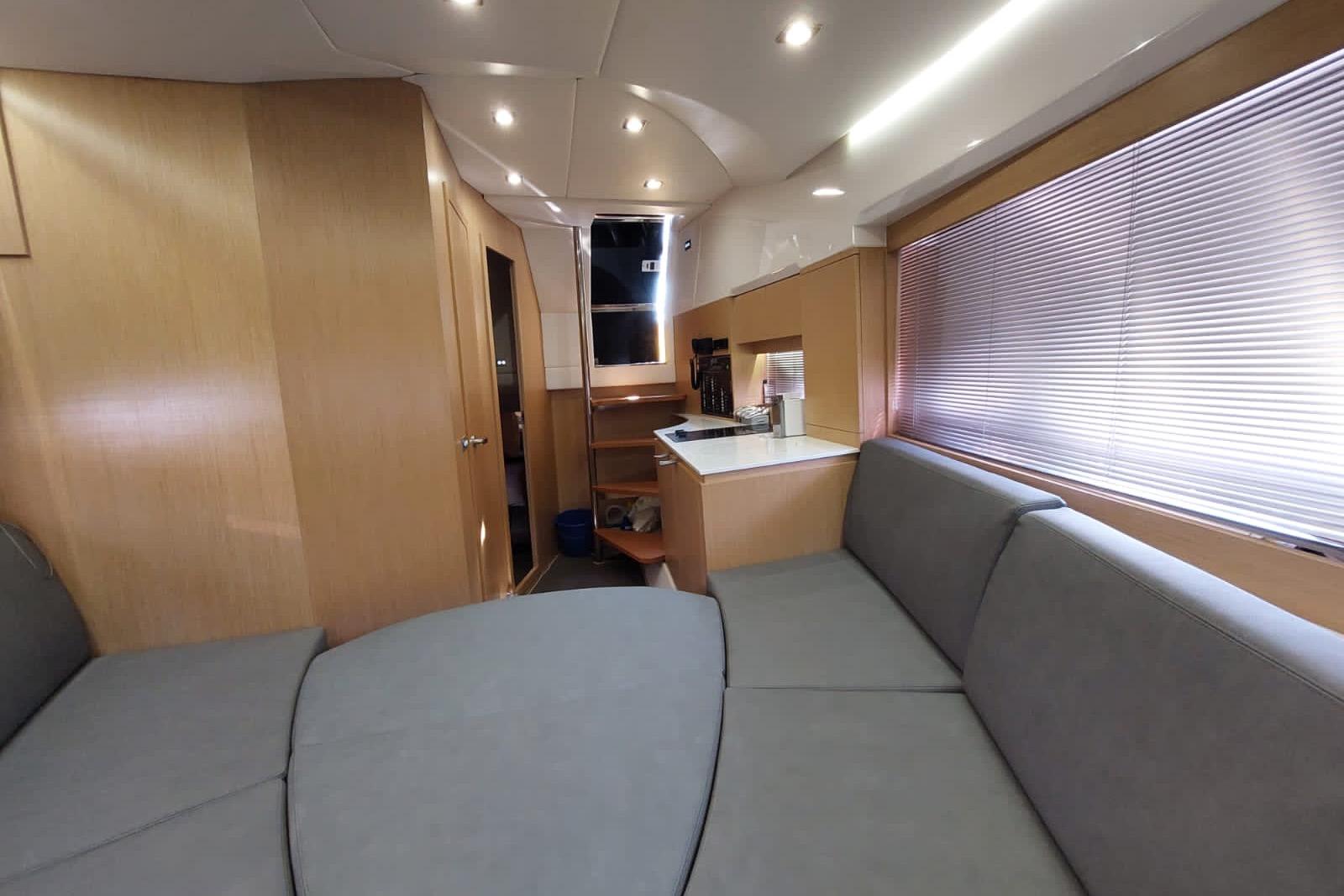 Modern interior of 2017 Need Yacht 32 with cozy seating and sleek design.