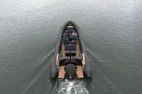 Ribeye A811 boat cruising on water, rear view, 2022 model.