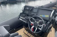 Steering console of 2022 Ribeye A811 boat with navigation display and controls.