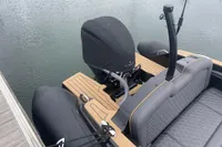 Ribeye A811 boat, 2022 model, with covered outboard motor and sleek seating, docked on water.