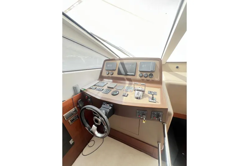  Yacht Photos Pics Cockpit of 2010 Numarine 78 yacht with steering wheel and control panel.