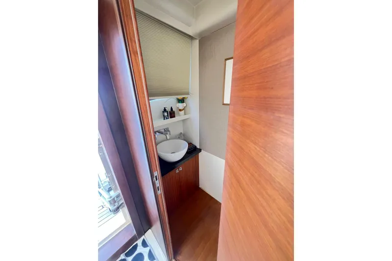  Yacht Photos Pics Compact bathroom on 2010 Numarine 78 yacht with modern sink and wooden accents.