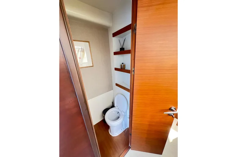  Yacht Photos Pics Compact bathroom on 2010 Numarine 78 yacht with wooden shelves and modern design.