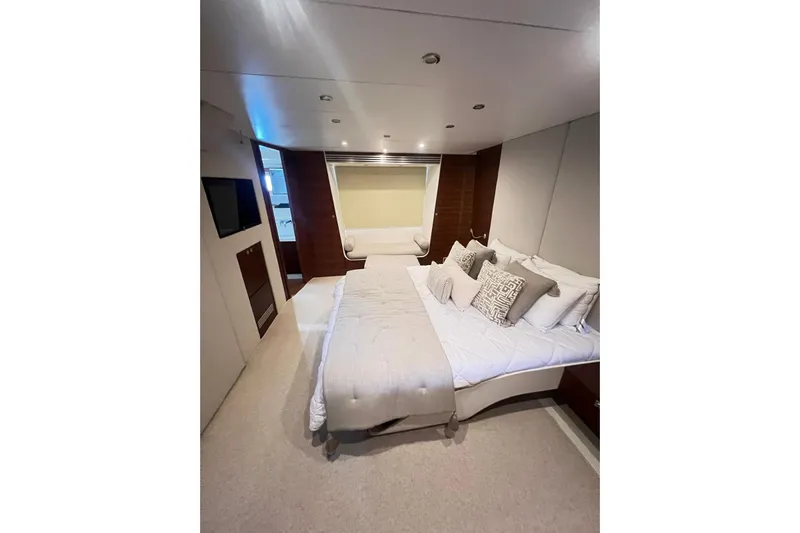  Yacht Photos Pics Luxurious bedroom interior on 2010 Numarine 78 yacht, featuring elegant bedding and modern design.