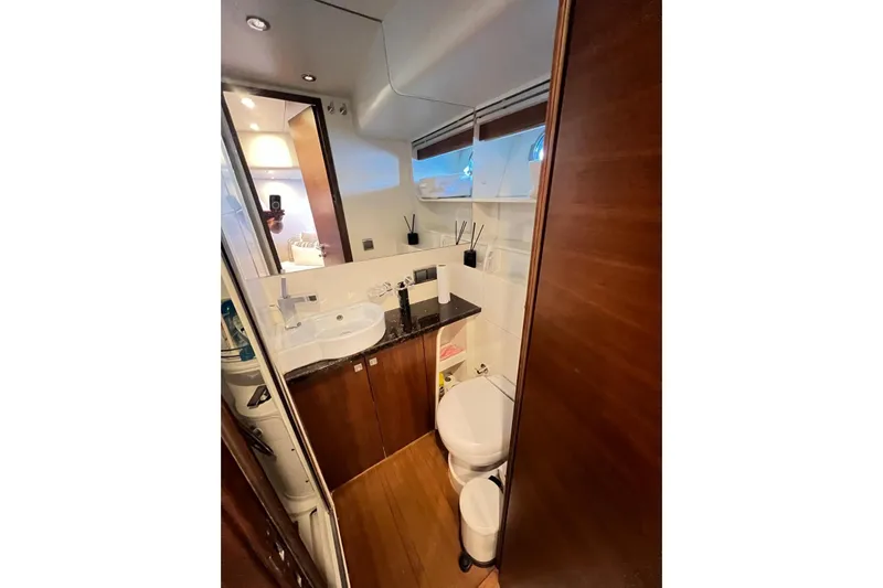  Yacht Photos Pics Luxurious bathroom in 2010 Numarine 78 yacht with modern fixtures and wooden accents.