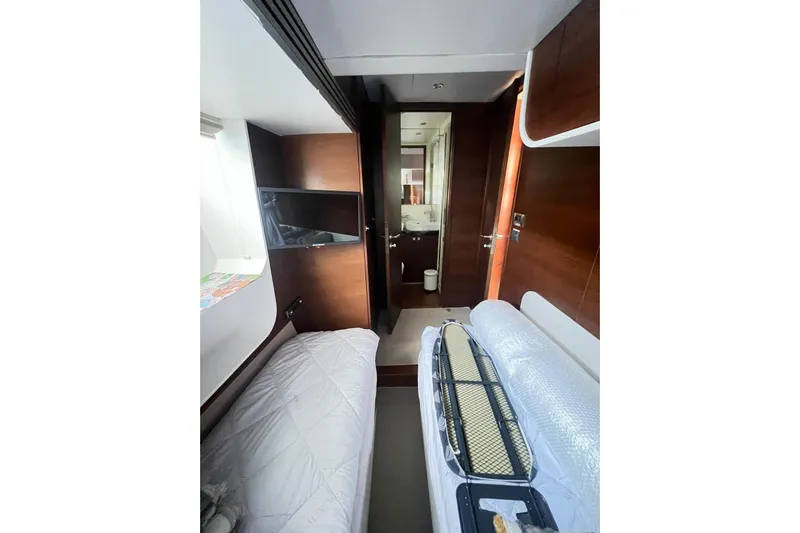  Yacht Photos Pics Interior of 2010 Numarine 78 yacht cabin with bed, TV, and bathroom view.