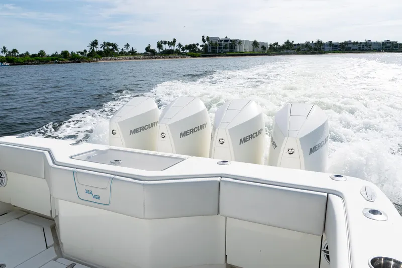  Yacht Photos Pics 2021 SeaVee 390 boat with four Mercury engines cruising on open water.