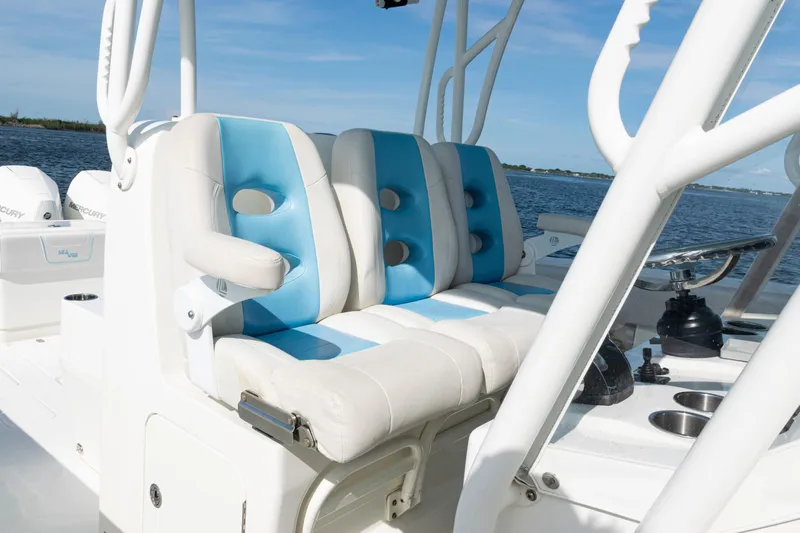  Yacht Photos Pics 2021 SeaVee 390 boat interior with blue and white seating, ocean view in background.