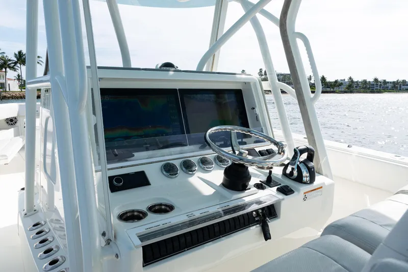  Yacht Photos Pics 2021 SeaVee 390 boat dashboard with steering wheel and navigation screens.