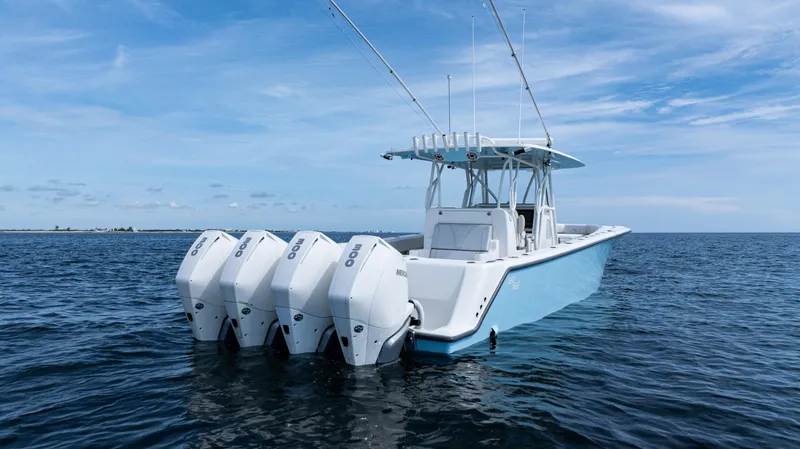  Yacht Photos Pics 2021 SeaVee 390 boat with four engines on open water under blue sky.