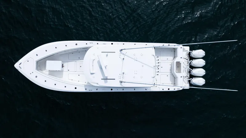  Yacht Photos Pics Aerial view of 2021 SeaVee 390 boat on dark water, showcasing sleek design and triple engines.