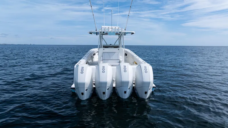  Yacht Photos Pics 2021 SeaVee 390 boat with four engines on open water under blue sky.