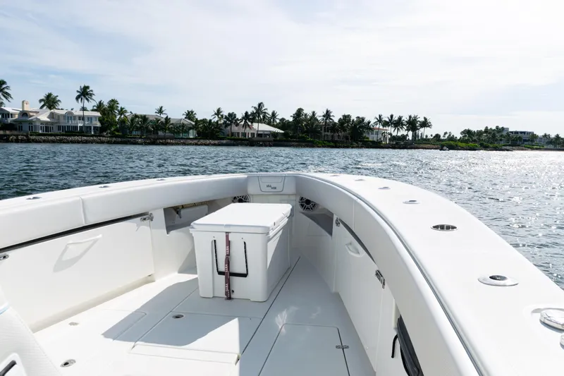  Yacht Photos Pics 2021 SeaVee 390 boat on water, with coastal homes and palm trees in the background.