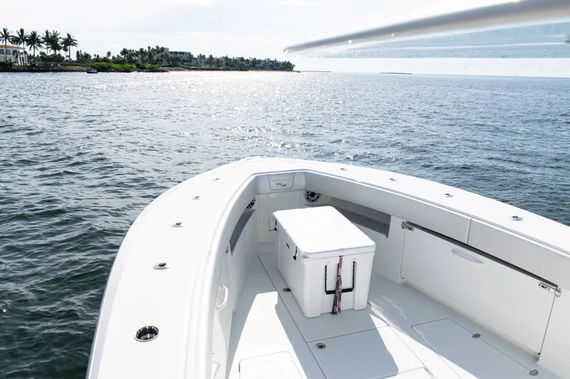  Yacht Photos Pics 2021 SeaVee 390 boat on calm water, featuring spacious deck and storage.