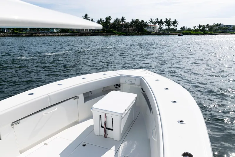  Yacht Photos Pics 2021 SeaVee 390 boat on water, featuring spacious deck and cooler.