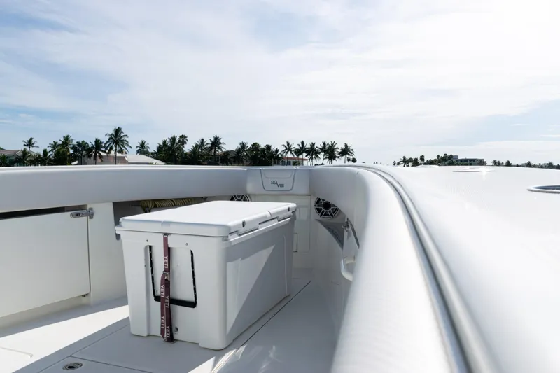  Yacht Photos Pics 2021 SeaVee 390 boat deck with cooler, palm trees in background, sunny day.