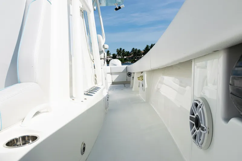  Yacht Photos Pics 2021 SeaVee 390 boat deck with white seating and speakers, under clear blue sky.