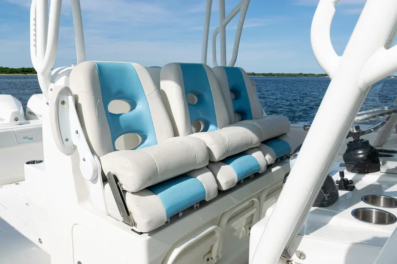  Yacht Photos Pics 2021 SeaVee 390 boat with blue and white cushioned seats on a sunny day.