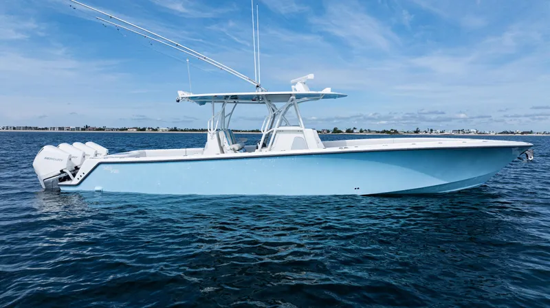  Yacht Photos Pics 2021 SeaVee 390 boat on calm water, featuring a sleek design and multiple outboard engines.