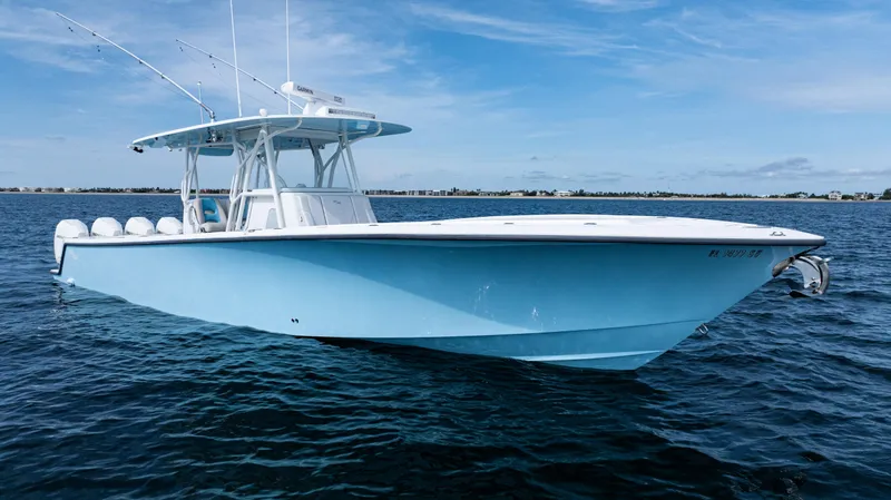  Yacht Photos Pics 2021 SeaVee 390 boat on calm ocean waters under a clear blue sky.