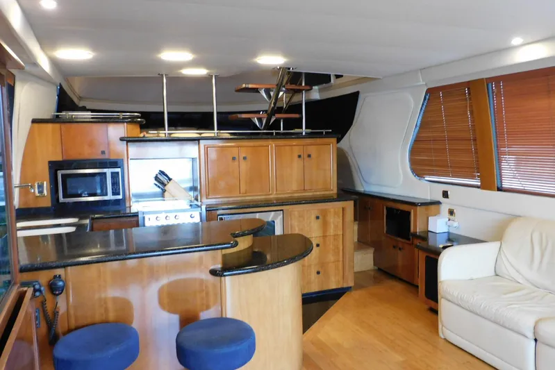 Waterdog Yacht Photos Pics Luxurious interior of 2002 Carver 570 Voyager Pilothouse yacht with modern kitchen and seating.
