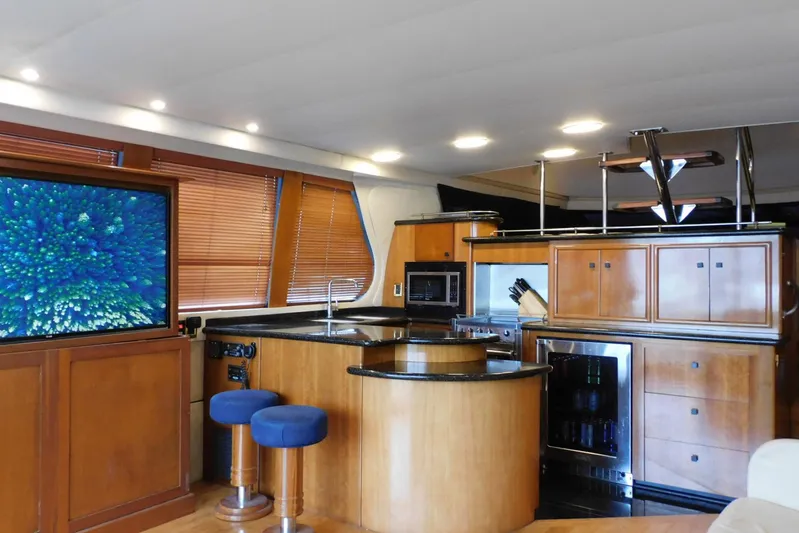 Waterdog Yacht Photos Pics Luxurious interior of 2002 Carver 570 Voyager Pilothouse yacht with modern kitchen and entertainment area.