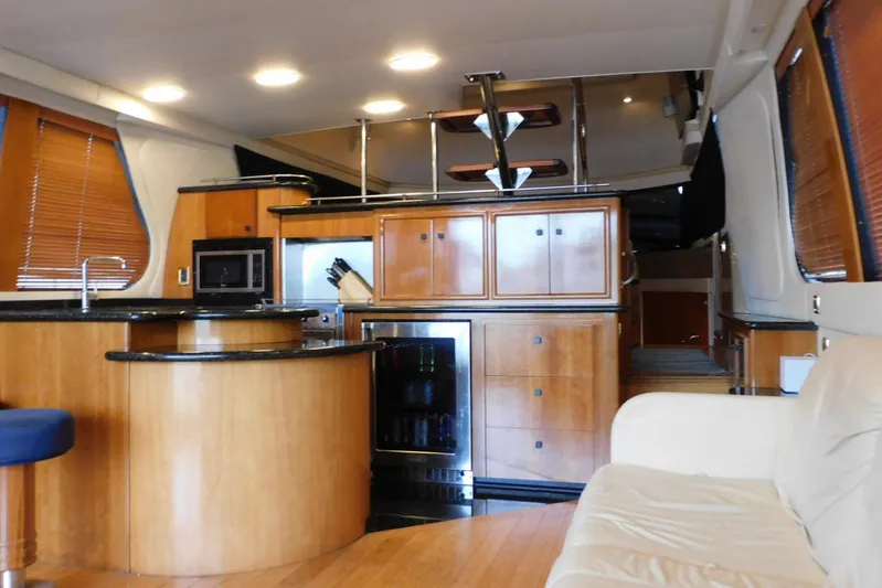 Waterdog Yacht Photos Pics Luxurious interior of 2002 Carver 570 Voyager Pilothouse with modern kitchen and seating area.